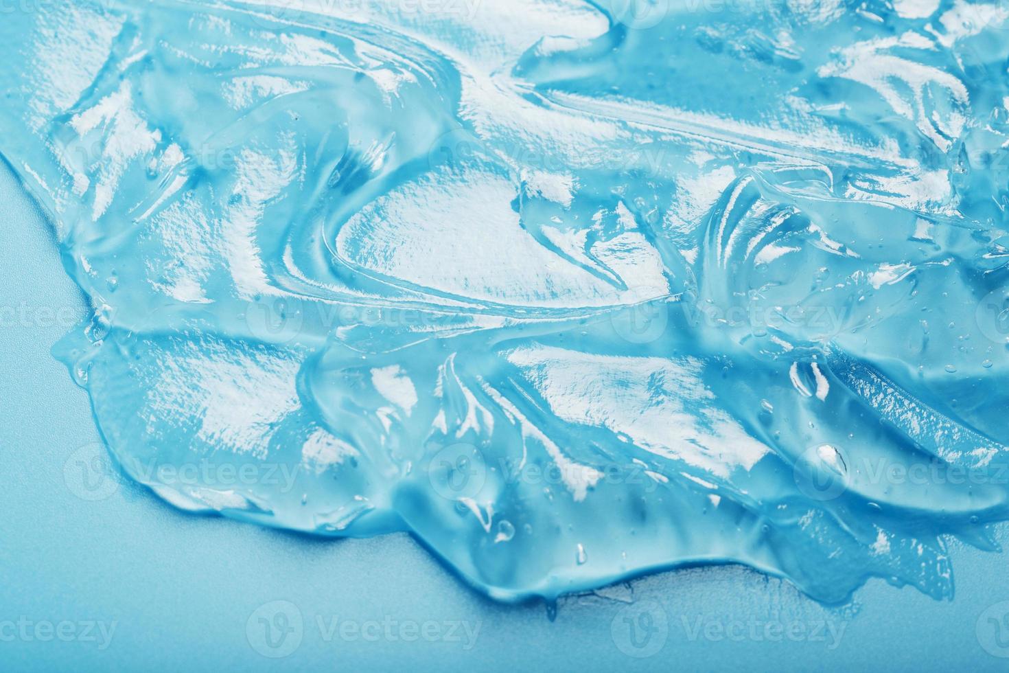 Antiseptic gel on a blue background in waves. photo