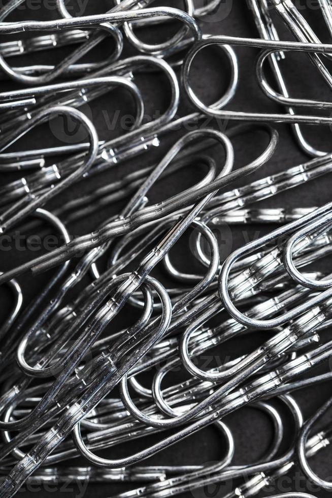 Silver paper clips textured background full screen photo