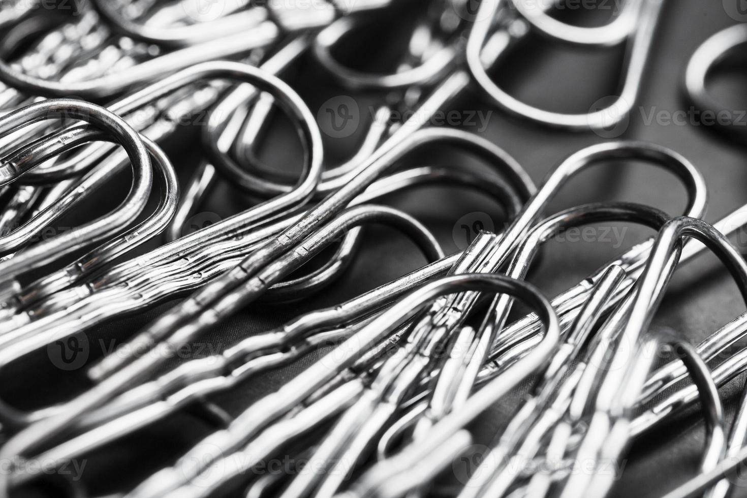 Silver paper clips textured background full screen photo