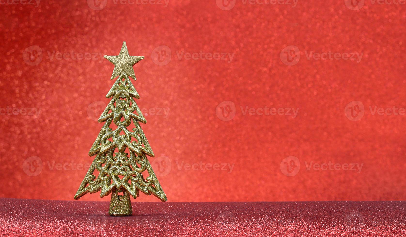 Christmas tree on a red background with glitter, sparkles with place for text. New Year. Copy space photo