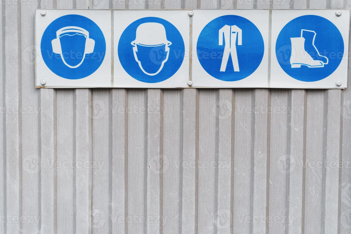 Safety signs and posters of personal protective equipment at work photo