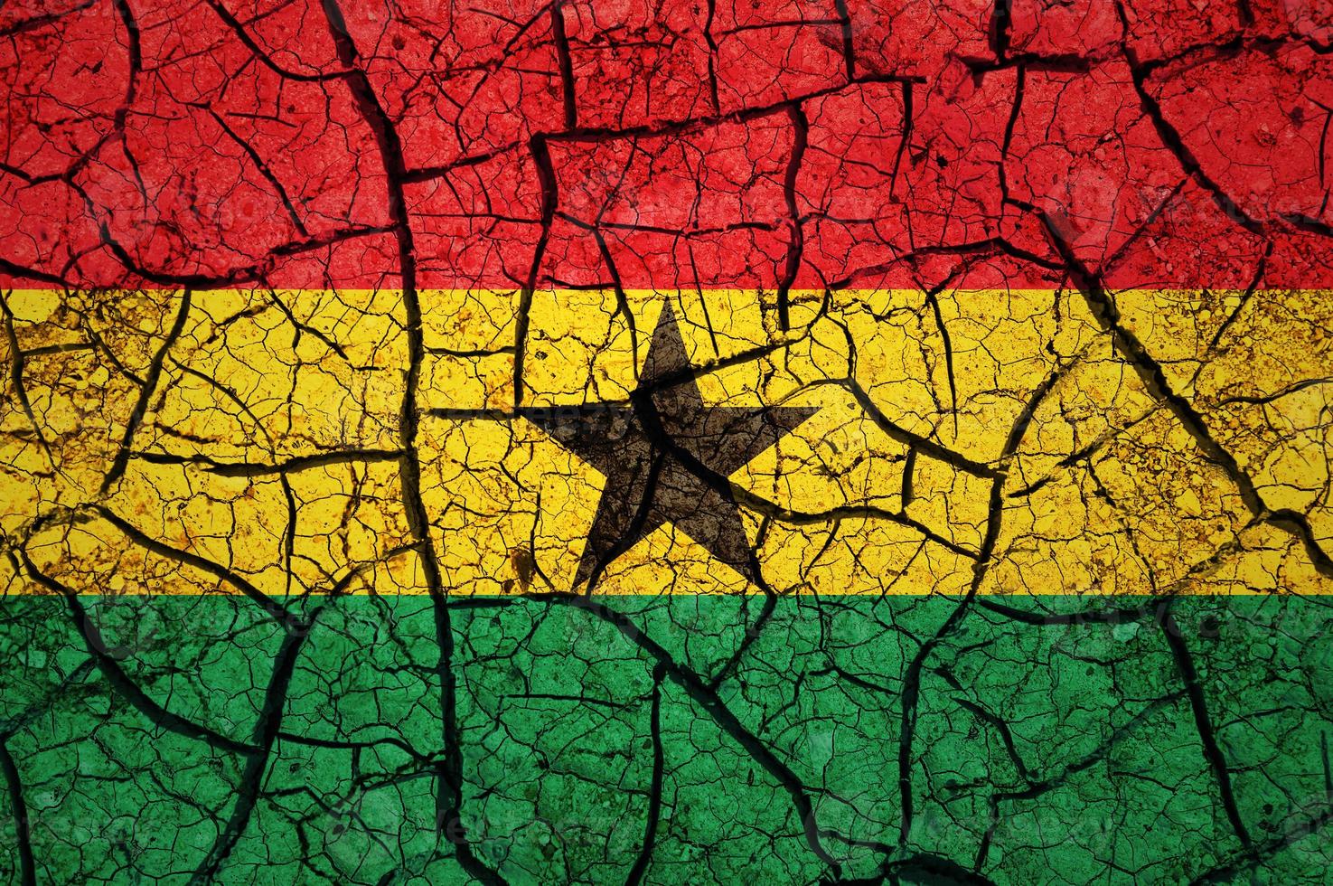 Dry soil pattern on the flag of Ghana. Country with drought concept. Water problem. Dry cracked earth country. photo