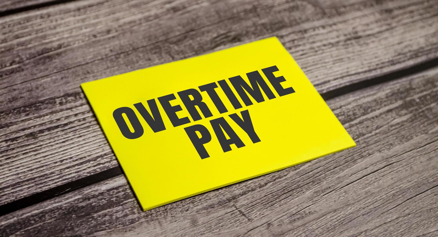 In the yellow sticker the text concept word overtime pay photo