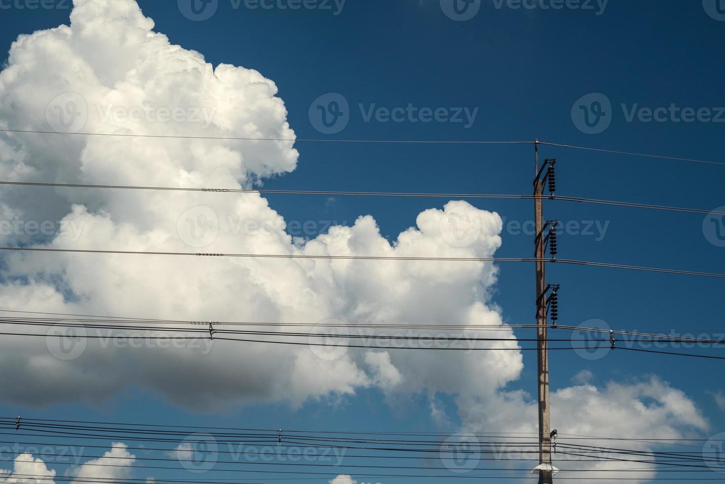 Modern electricity pole with lantern and power line cables. Blue sky and cloud as background. Concept of modern engineering knowledge for power transmission, connection, communication. photo