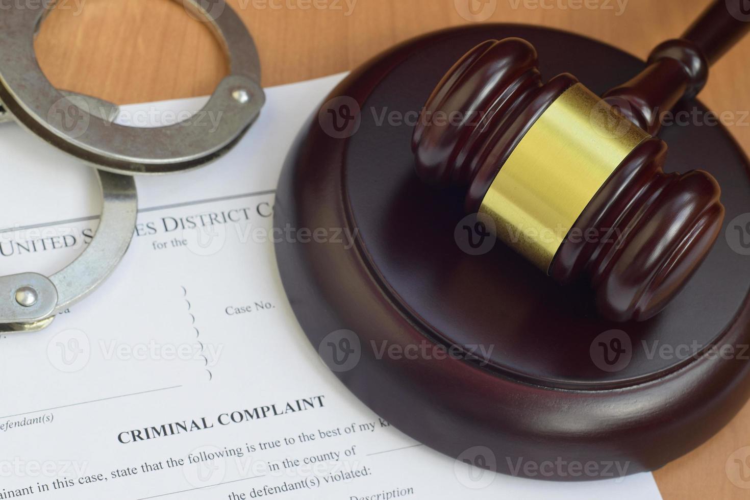 Justice mallet and criminal complaint blank document with police handcuffs photo