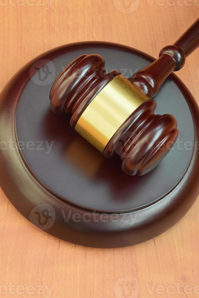 Justice mallet on wooden desk in a courtroom during a judicial trial. Law concept and empty space for text. Judge hammer photo