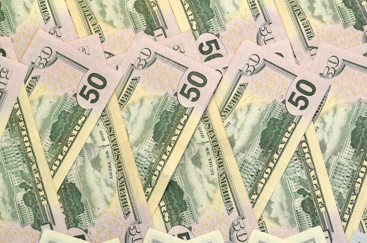 Many one hundred and fifty dollar bills on flat background surface close up. Flat lay top view photo