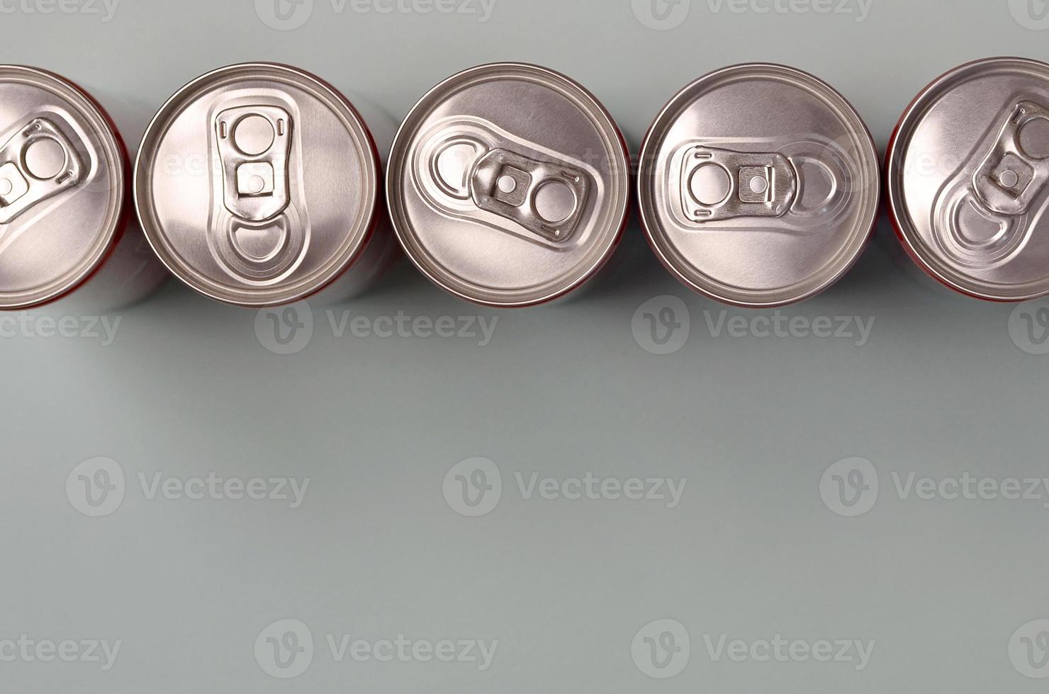 Many new aluminium cans of soda soft drink or energy drink containers. Drinks manufacturing concept and mass production photo