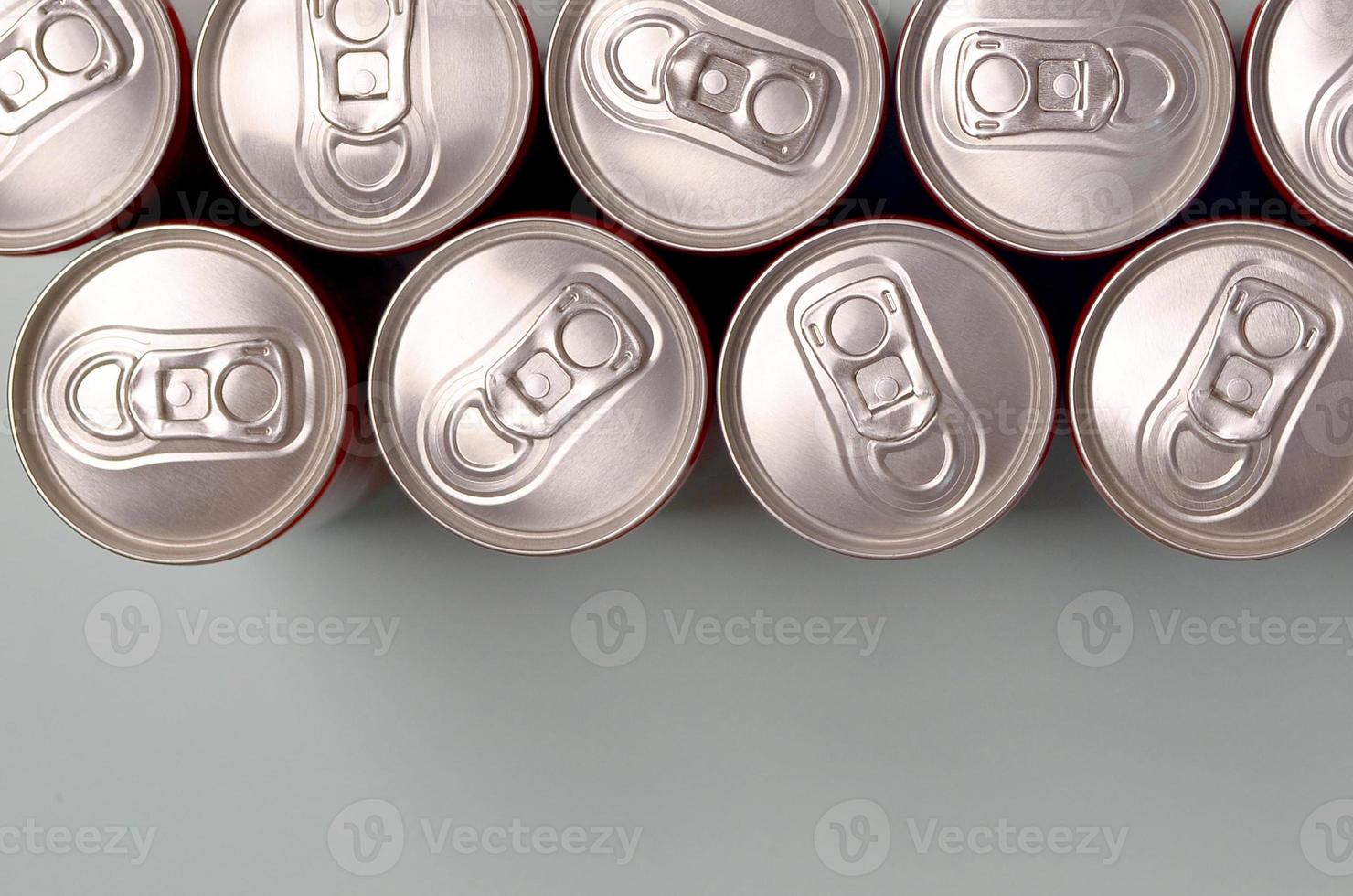 Many new aluminium cans of soda soft drink or energy drink containers. Drinks manufacturing concept and mass production photo
