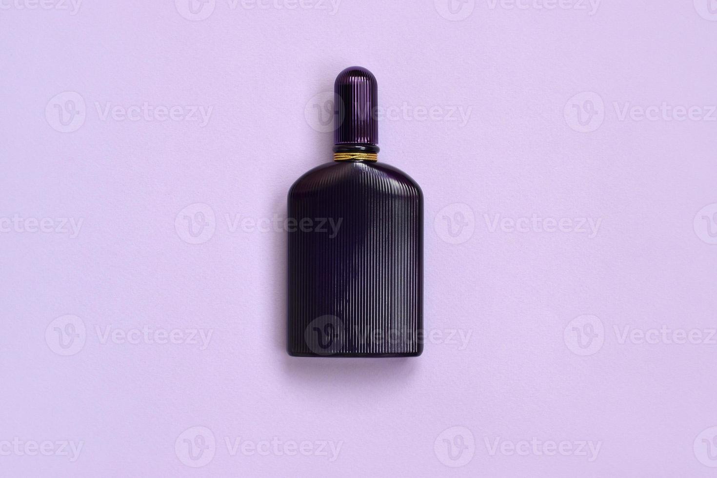 Dark purple perfume bottle with golden ribbon on pastel paper