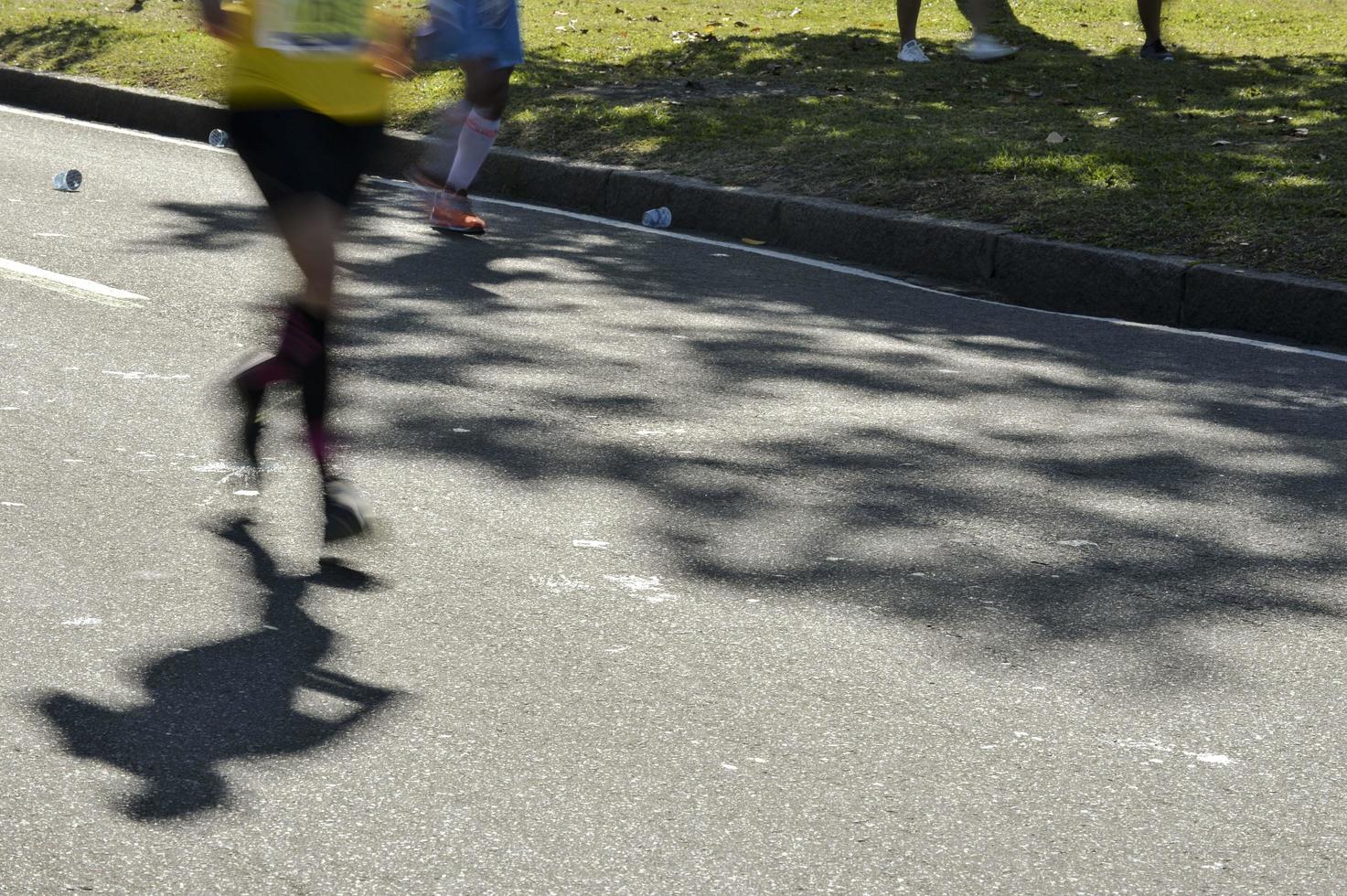 Street race, showing the blurs motion legs of the runners photo