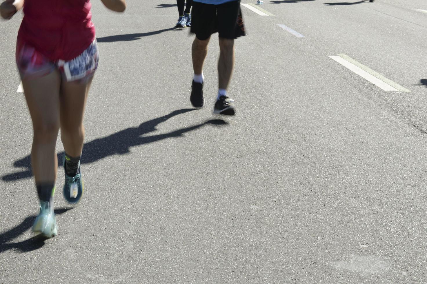 Street race, showing the blurs motion legs of the runners photo