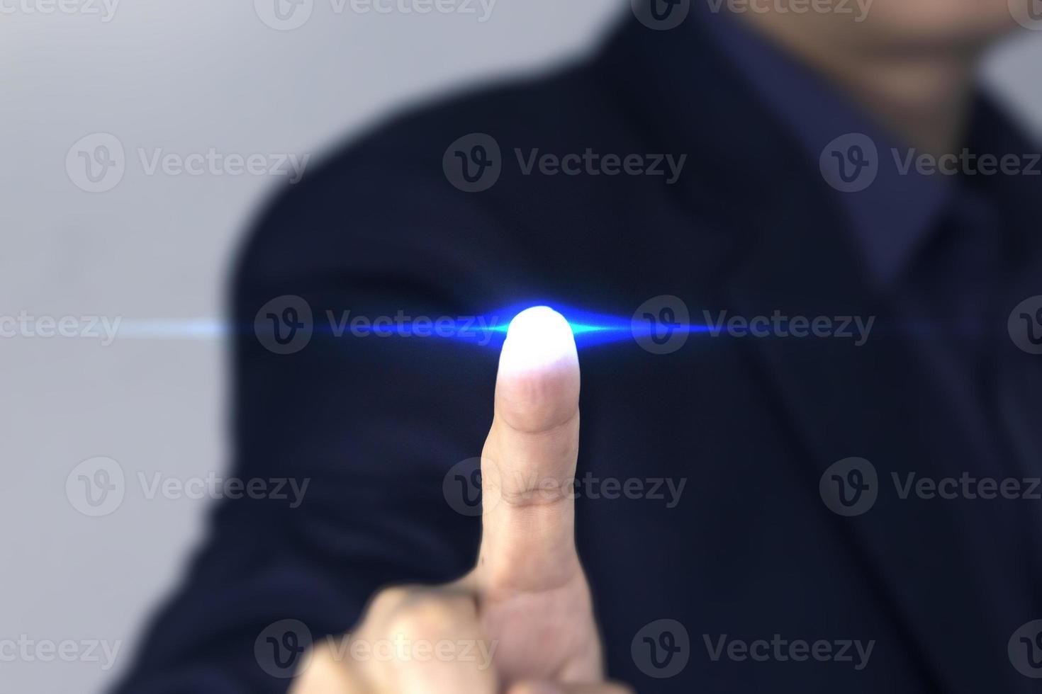 A Businessman finger touching technology blue Light, A smart businessman clicking a blue flare effect of virtual screen, used in business and technology design photo