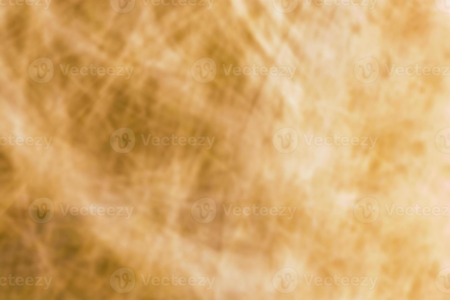 Abstract brown yellow crumpled slightly blurred background. photo