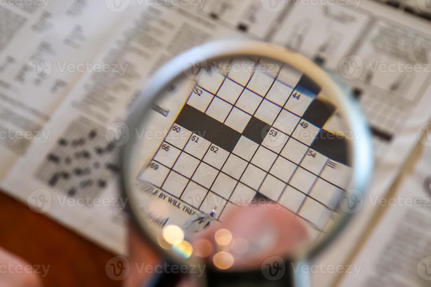 Close up view on international newspapers with a magnifying glass and a soft bokeh photo