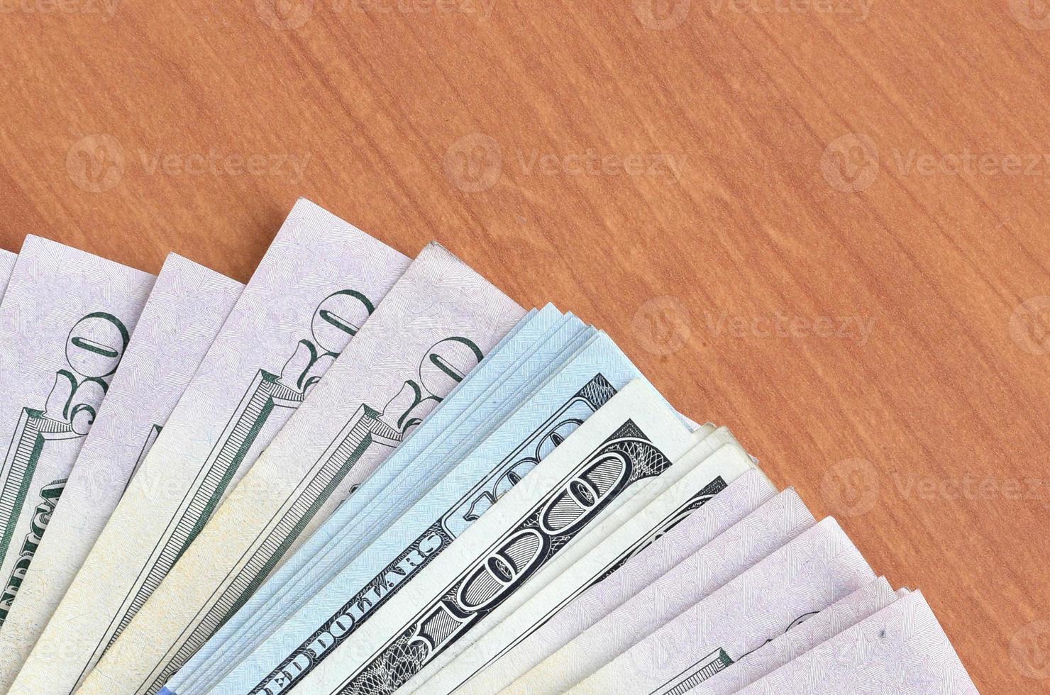 Fan of many one hundred and fifty dollar bills on wooden background surface close up. Flat lay top view. Abstract business concept photo