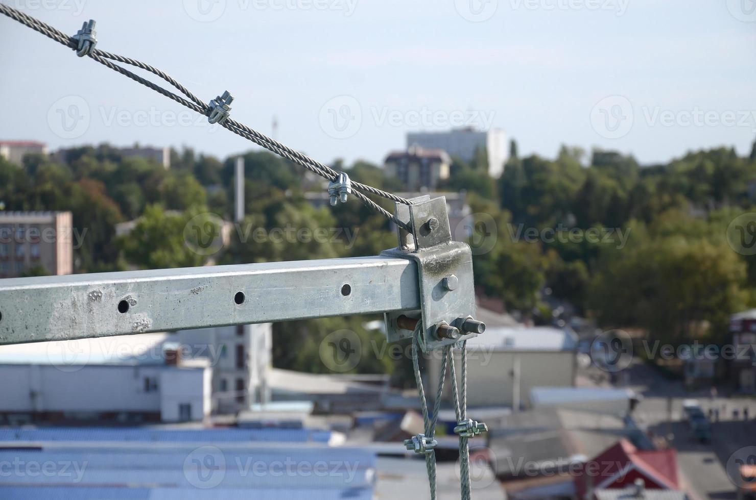 Rope lockers in ending of front beam of suspended wire rope platform for facade works on high multistorey buildings. Rope lockers blocks kink for safety platform usage photo