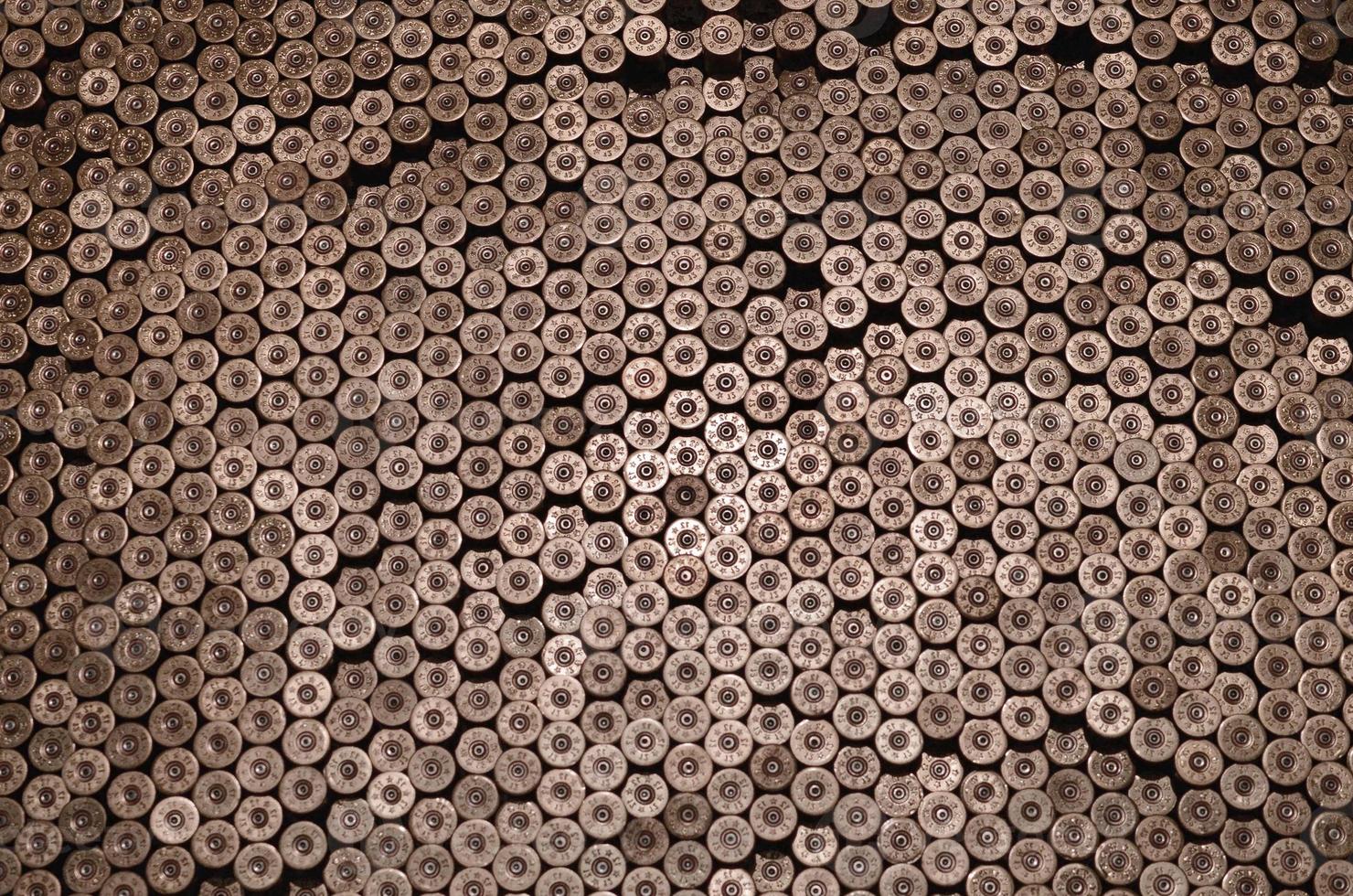 Pattern of 12 gauge cartridges for shotgun bullets. Shells for hunting rifle close up. Backdrop for shooting range or ammunition trade concepts photo