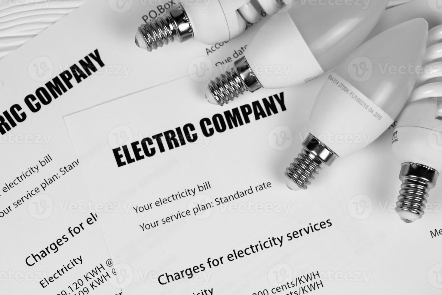 Abstract American electricity bill. Concept of saving money by using energy savings led light bulbs and electric bill payment photo