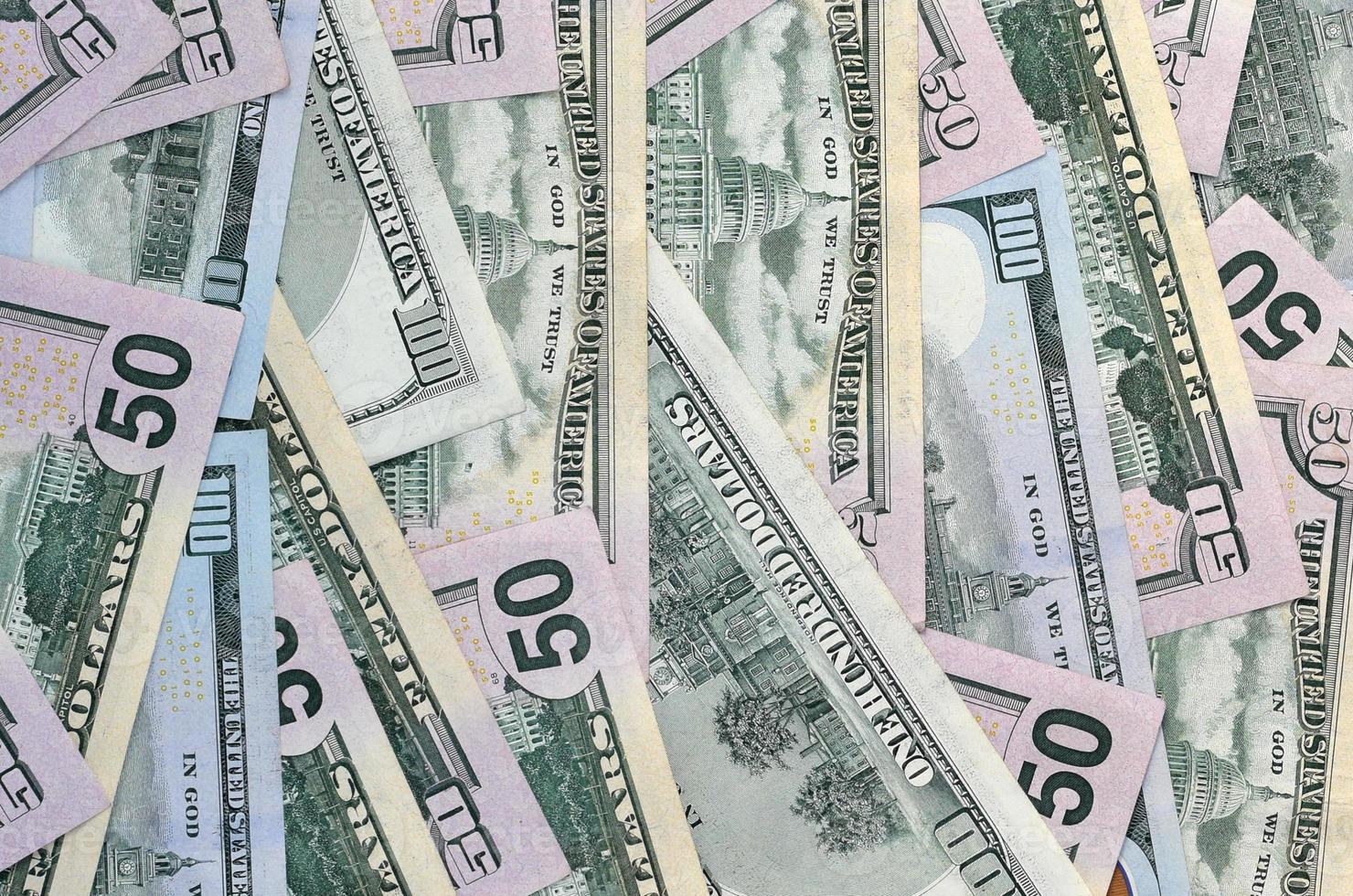 Many one hundred and fifty dollar bills on flat background surface close up. Flat lay top view photo