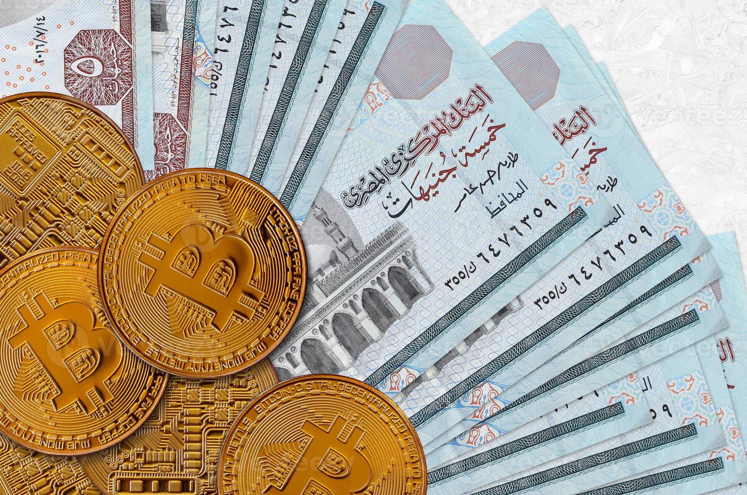 5 Egyptian pounds bills and golden bitcoins. Cryptocurrency investment concept. Crypto mining or trading photo