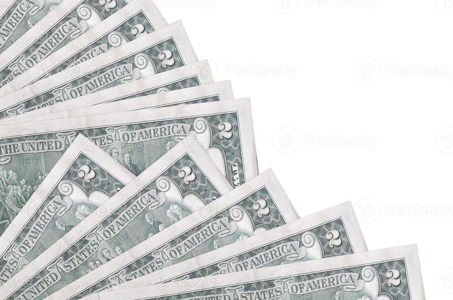2 US dollars bills lies isolated on white background with copy space stacked in fan close up photo