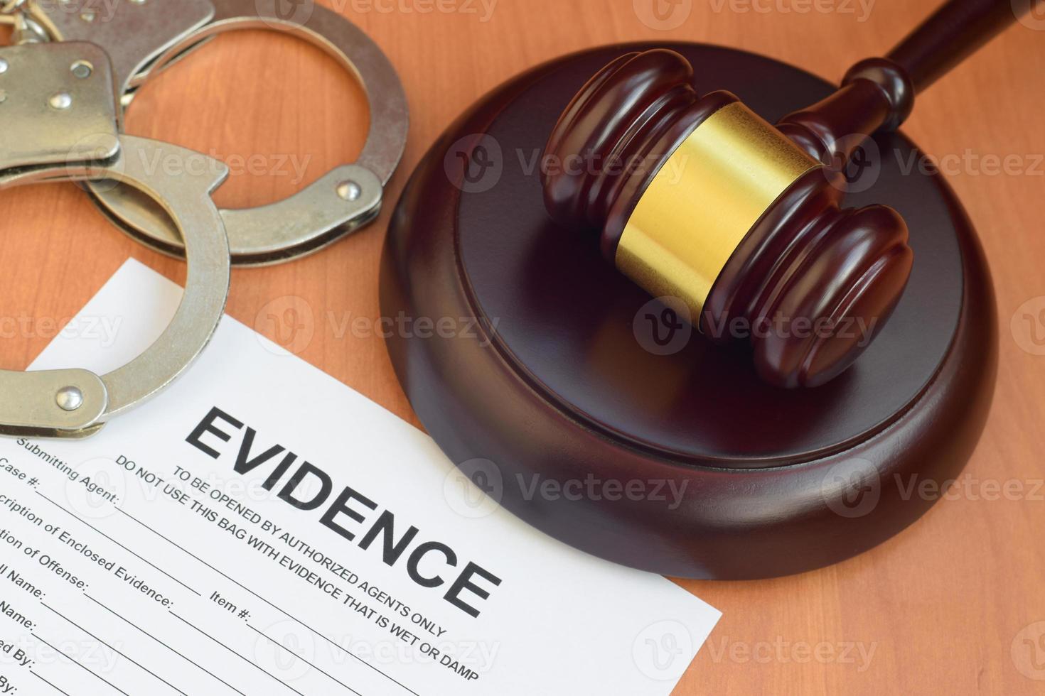 Justice mallet and evidence report blank document for crime scene investigation with police handcuffs photo