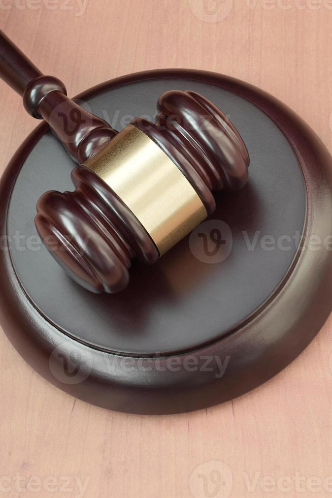 Justice mallet on wooden desk in a courtroom during a judicial trial. Law concept and empty space for text. Judge hammer photo