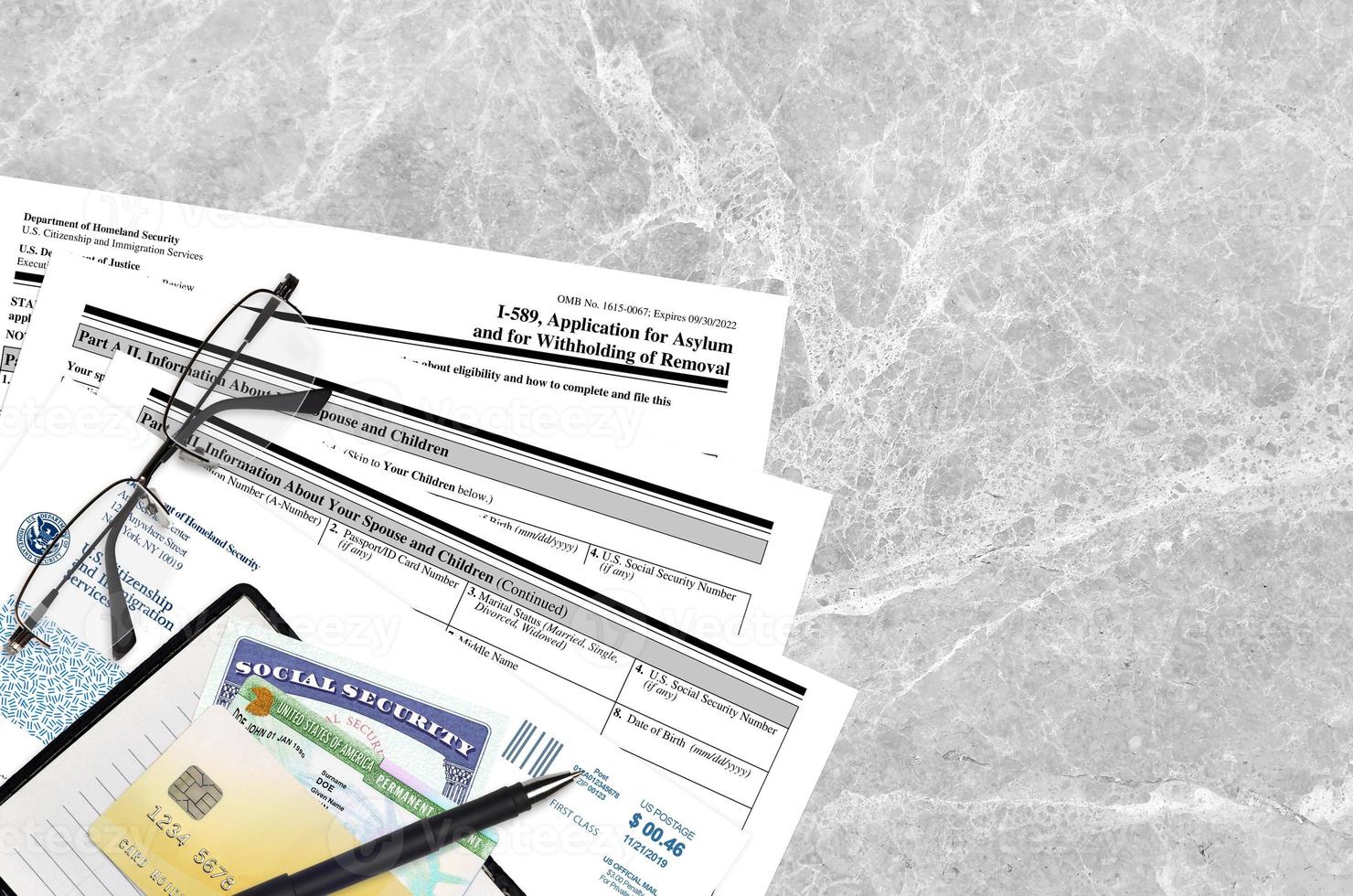 USCIS form I-589 Application of asylum and for withholding of removal lies on flat lay office table and ready to fill. U.S. Citizenship and Immigration services paperwork concept photo