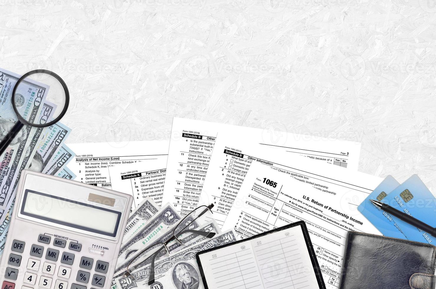 IRS form 1065 U.S. Return of partnership income lies on flat lay office table and ready to fill. U.S. Internal revenue services paperwork concept. Time to pay taxes in United States photo