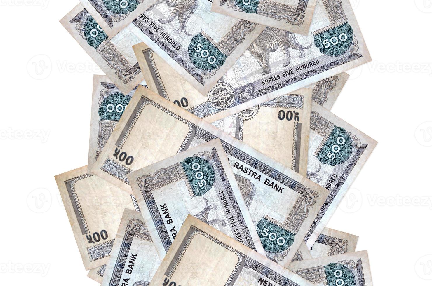 500 Nepalese rupees bills flying down isolated on white. Many banknotes falling with white copyspace on left and right side photo
