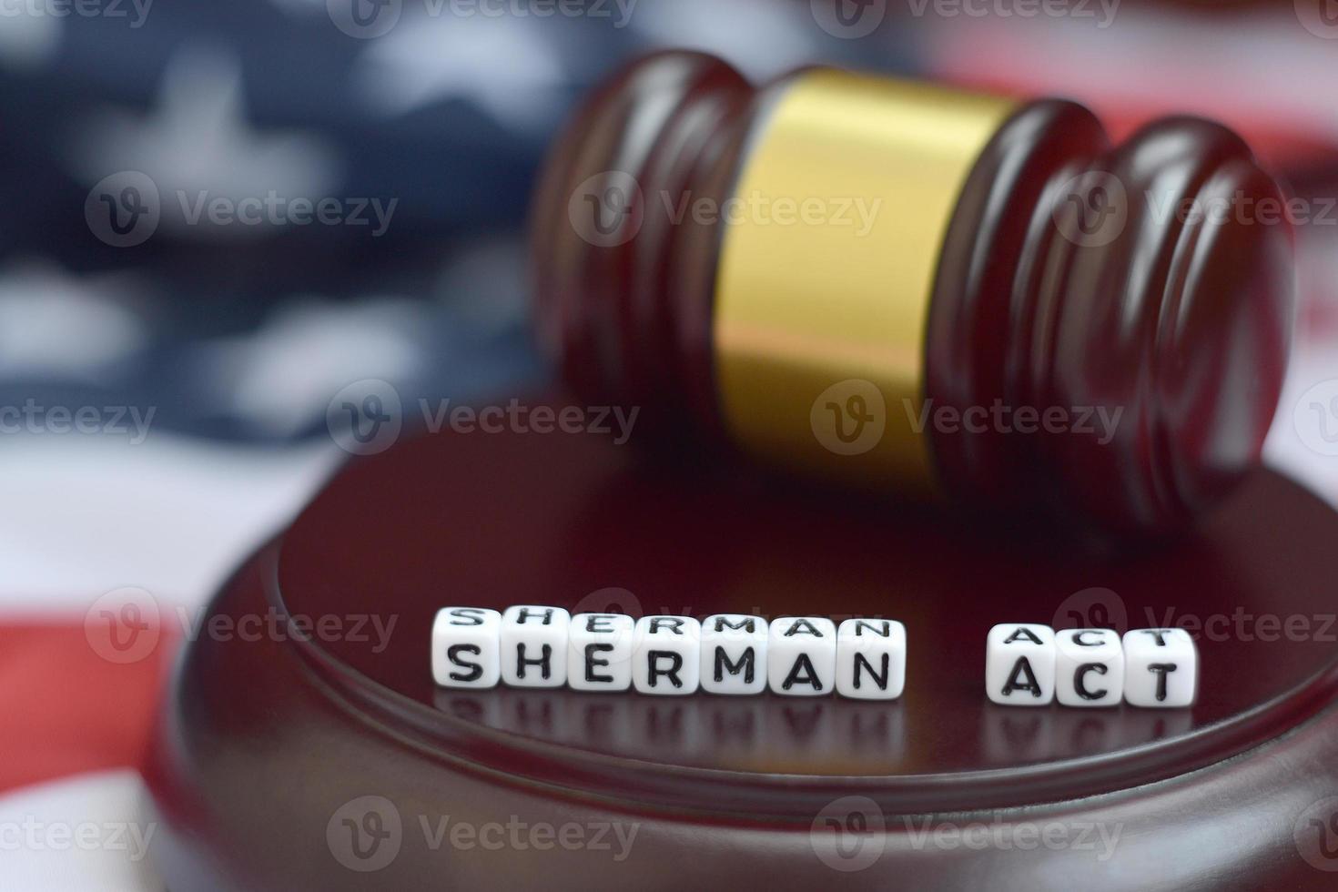 Justice mallet and Sherman act characters with US flag on background photo