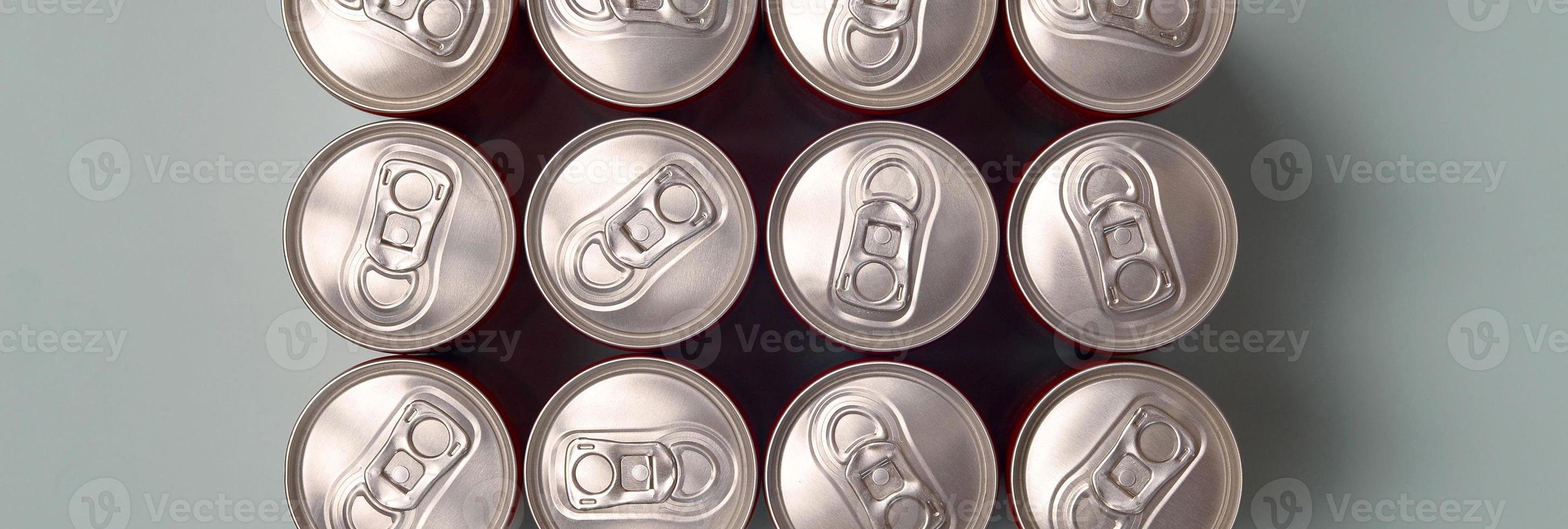 Many new aluminium cans of soda soft drink or energy drink containers. Drinks manufacturing concept and mass production photo