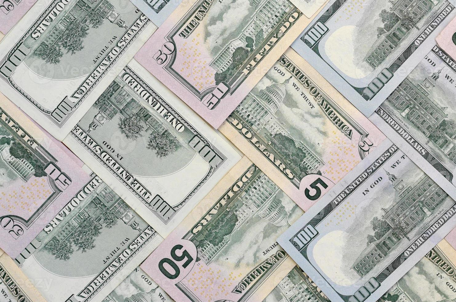 Many one hundred and fifty dollar bills on flat background surface close up. Flat lay top view photo