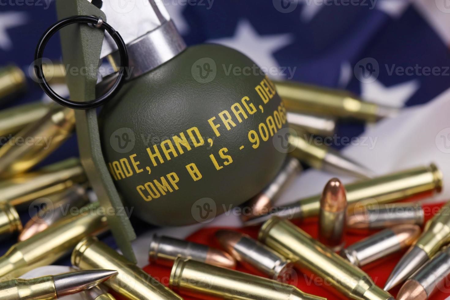 M67 frag grenade and many yellow bullets and cartridges on United States flag. Concept of gun trafficking on USA territory or spec ops photo