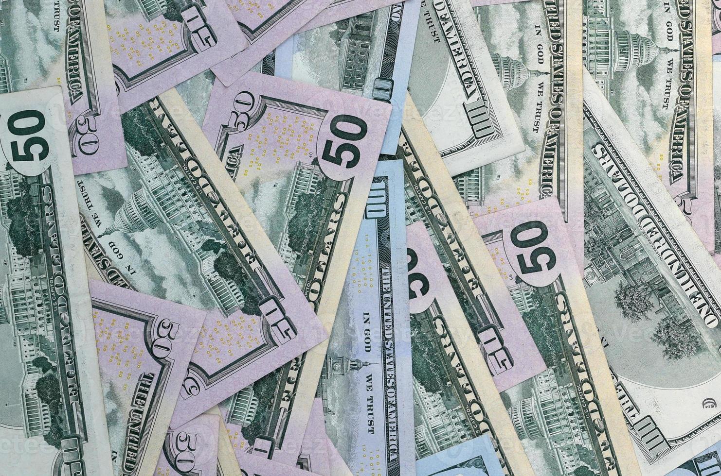Many one hundred and fifty dollar bills on flat background surface close up. Flat lay top view photo