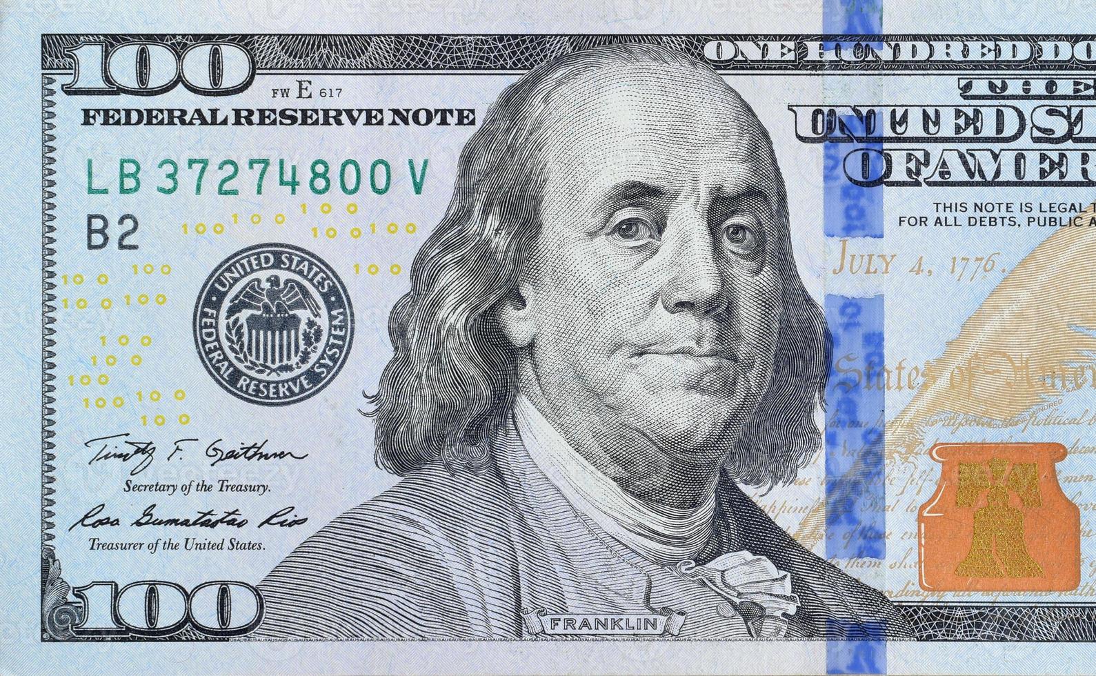 Portrait of US president Benjamin Franklin on 100 dollars banknote closeup macro fragment. United states hundred dollars money bill photo