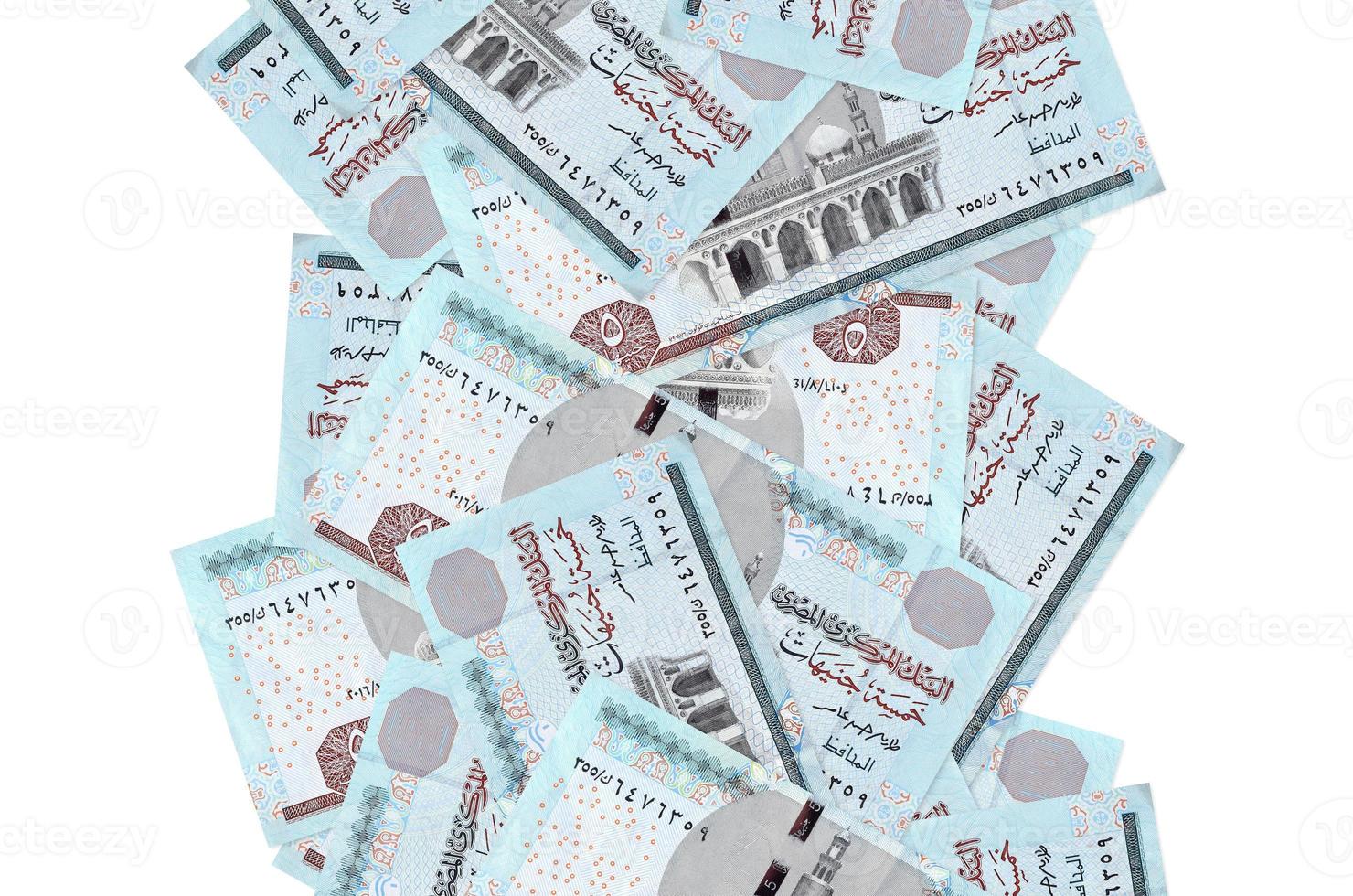 Billetes de 5 libras egipcias volando aislados en blanco. muchos billetes cayendo con copyspace blanco en el lado izquierdo y derecho foto