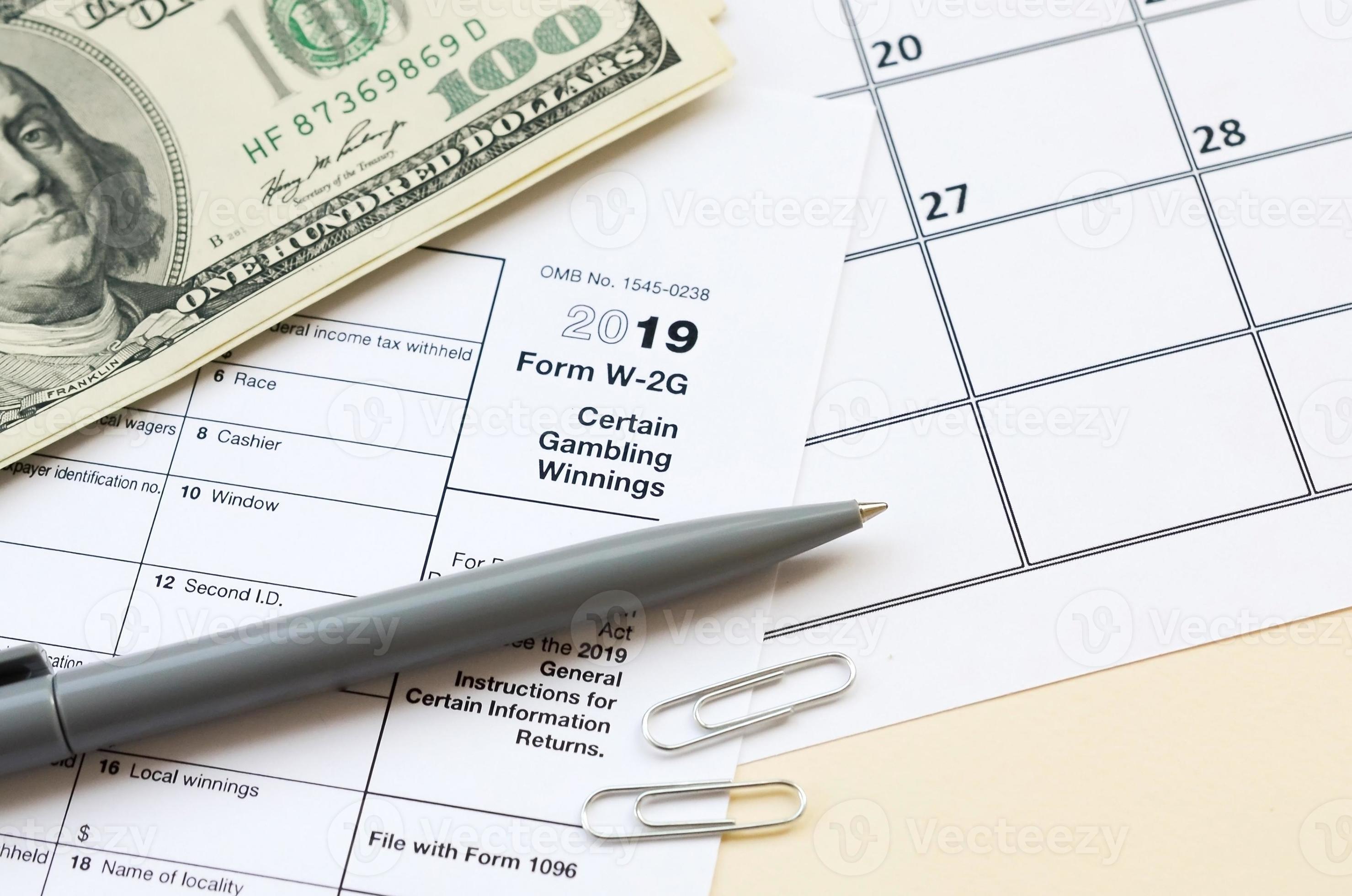 IRS Form W 2G Certain Gambling Winning blank lies with pen and many IRS Form W 2G Certain Gambling Winning blank lies with pen and many