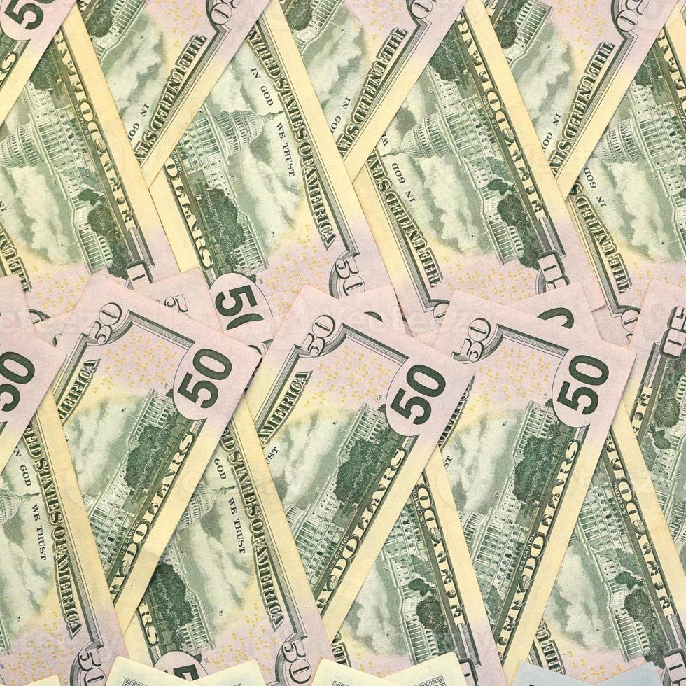 Many one hundred and fifty dollar bills on flat background surface close up. Flat lay top view photo