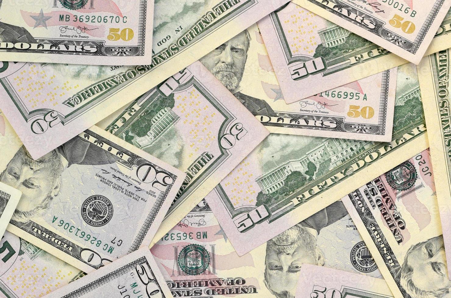 Many US fifty dollar bills on flat background surface close up. Flat lay top view. Abstract business concept photo