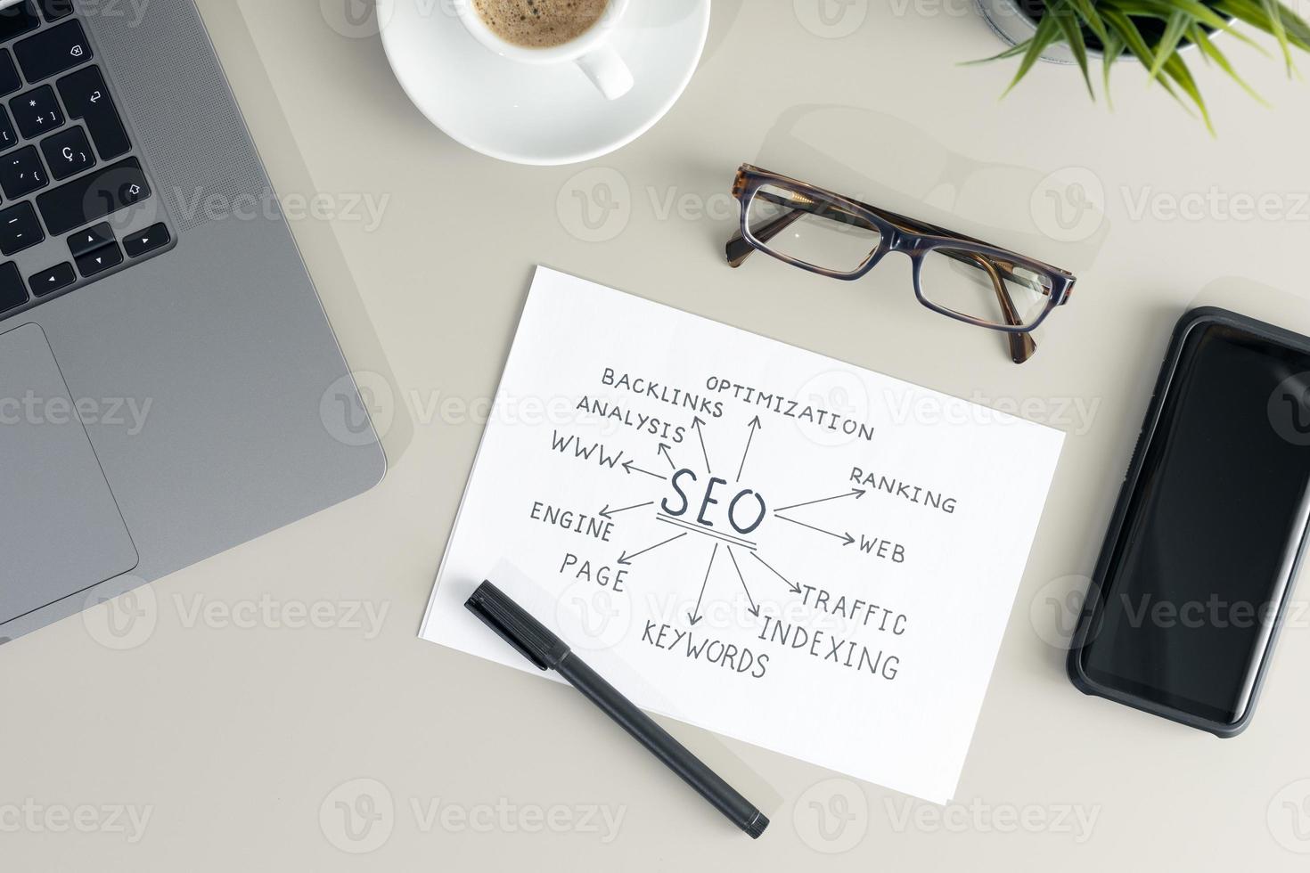Working desk with paper sheet with SEO planning. Search engine optimization concept. Flat lay photo