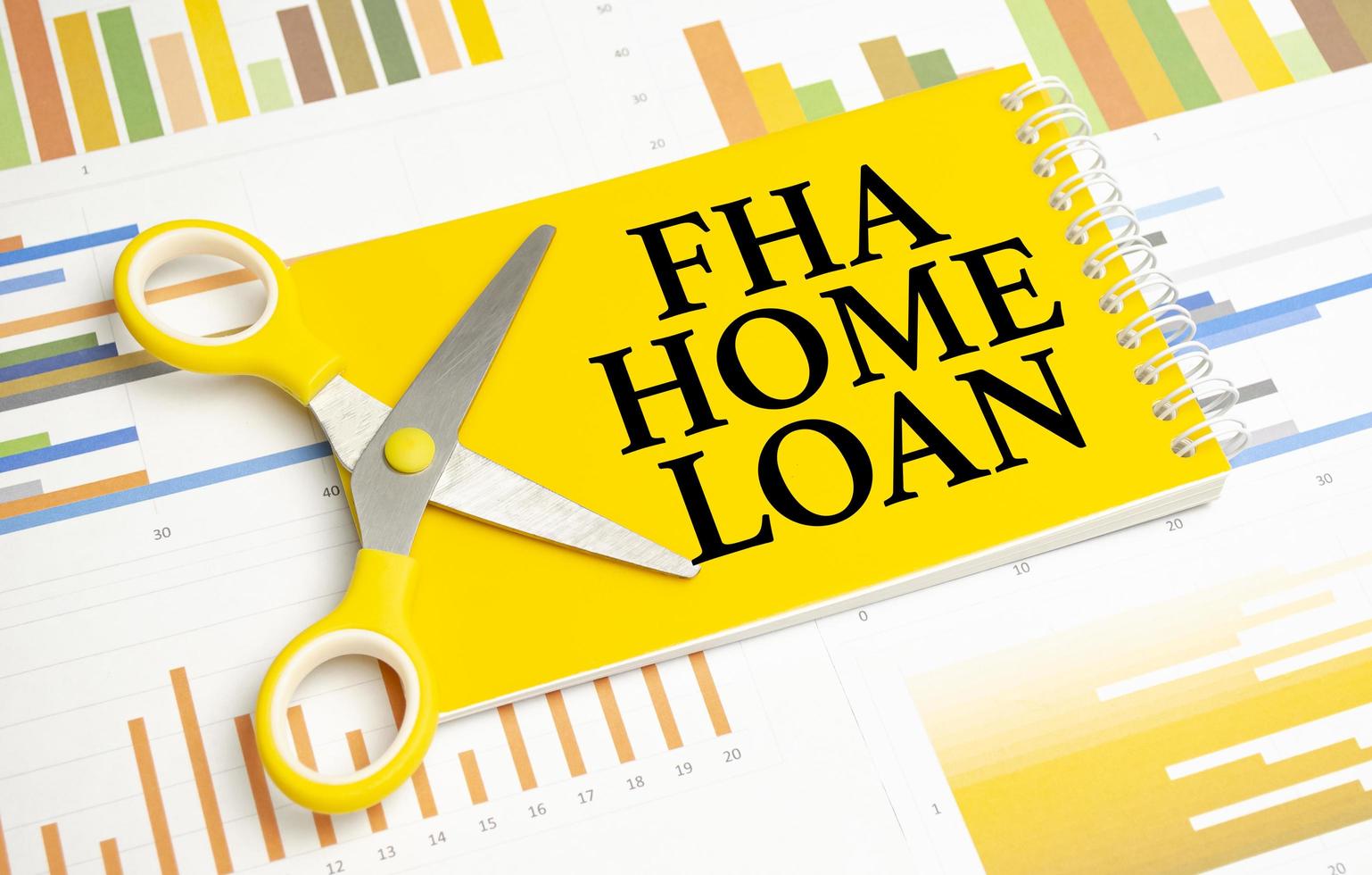 words FHA Home loan on notepad and pen, glasses on wooden background photo