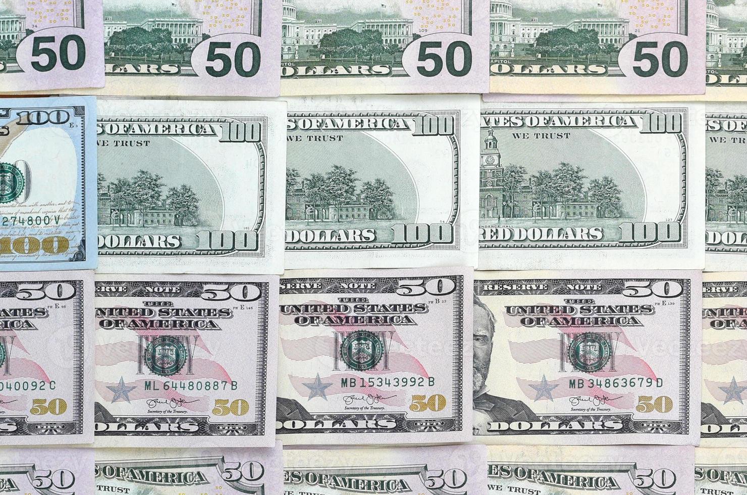 Many one hundred and fifty dollar bills on flat background surface close up. Flat lay top view photo