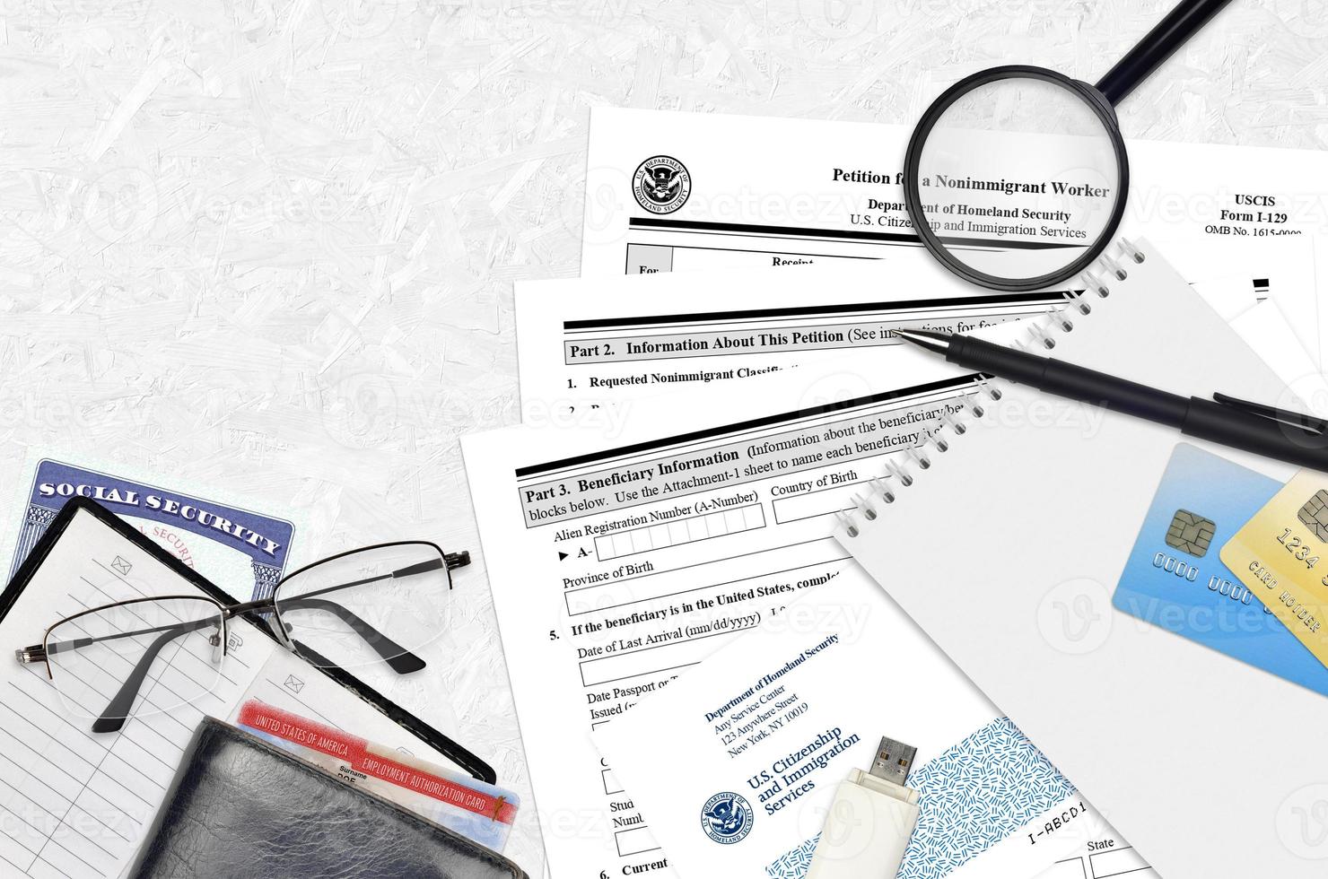 USCIS form I-129 Petition for a nonimmigrant worker lies on flat lay office table and ready to fill. U.S. Citizenship and Immigration services paperwork concept photo