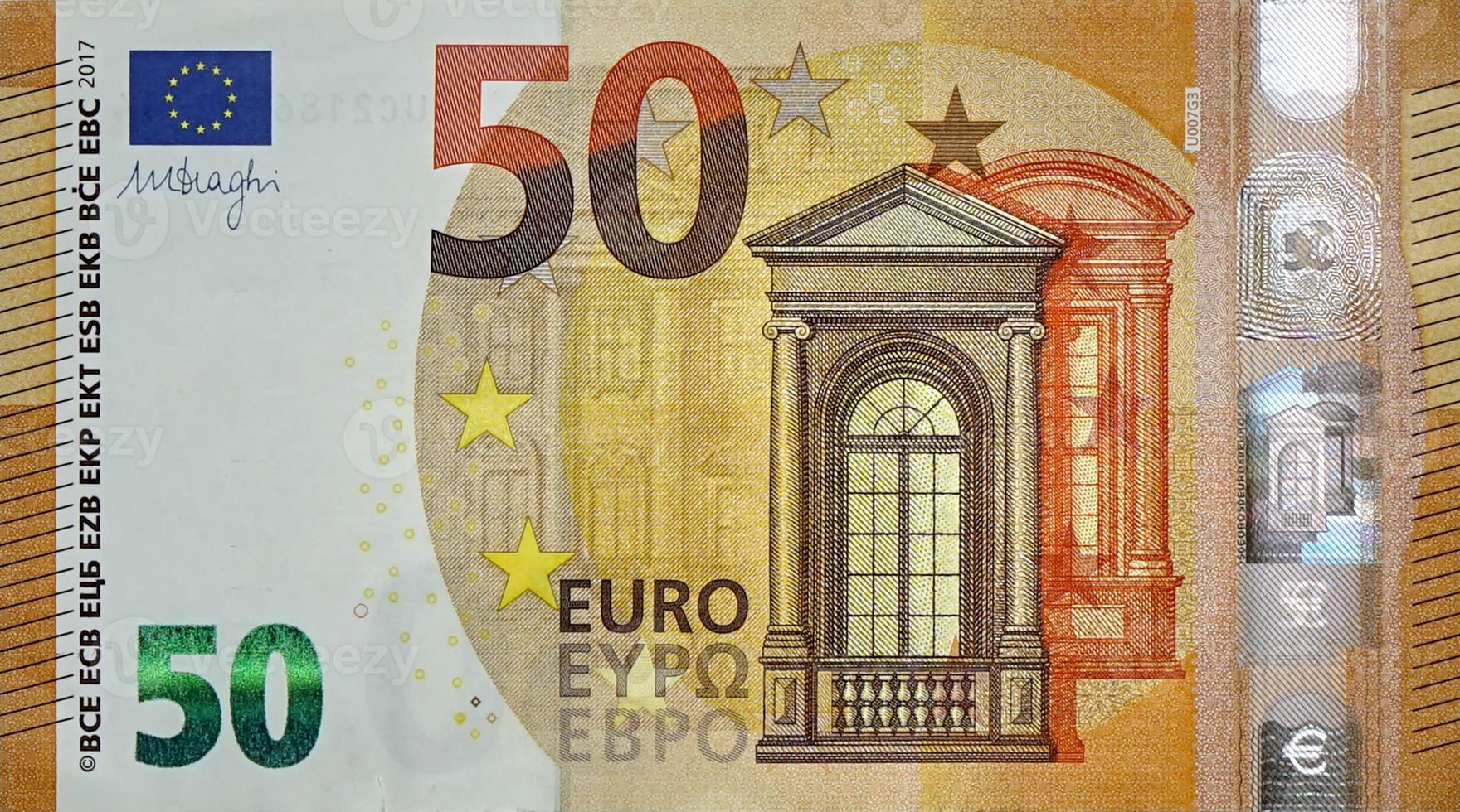 Fragment part of 50 euro banknote close-up with small brown details photo
