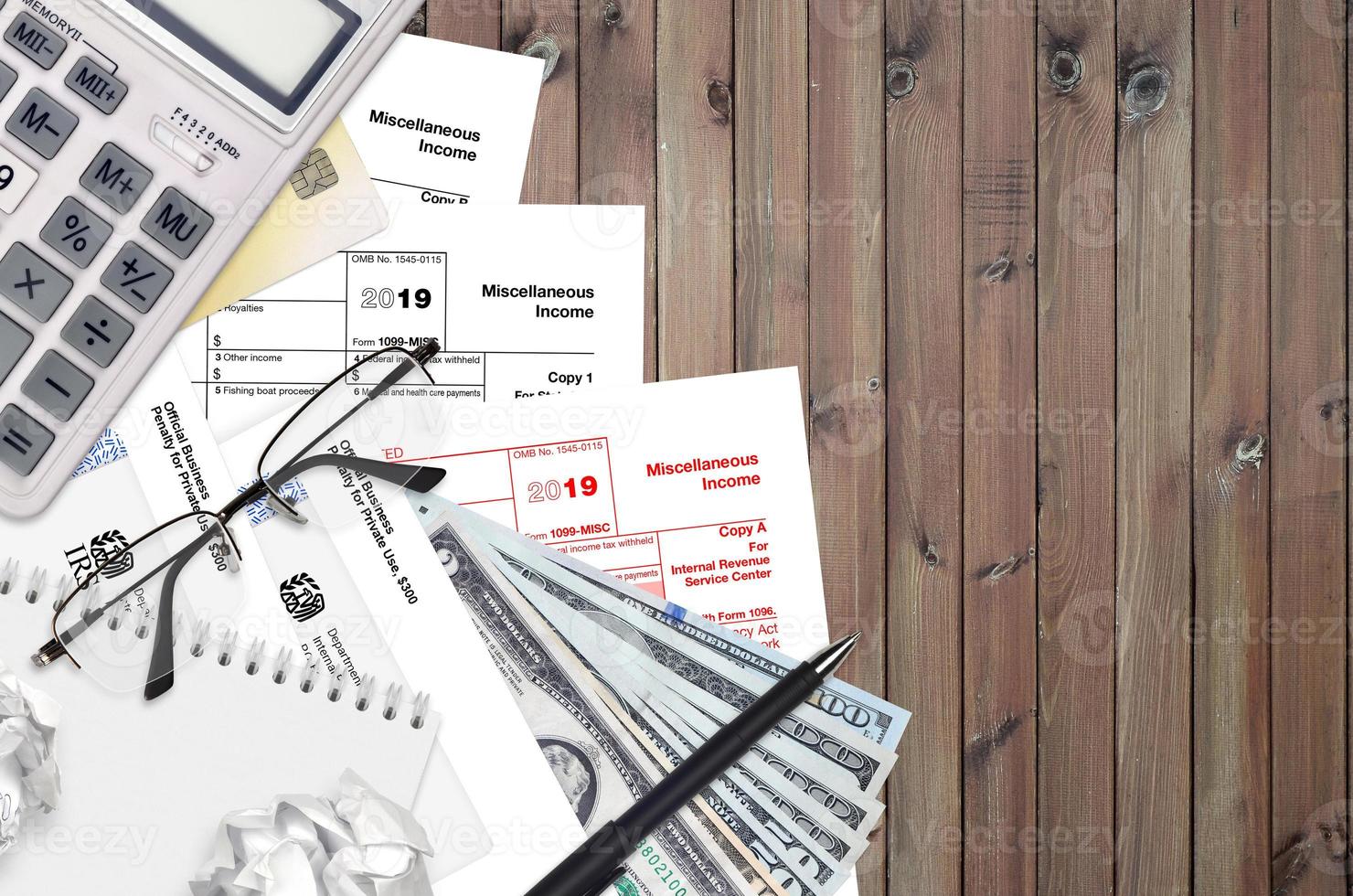 IRS form 1099-MISC Miscellaneous income lies on flat lay office table and ready to fill. U.S. Internal revenue services paperwork concept. Time to pay taxes in United States photo