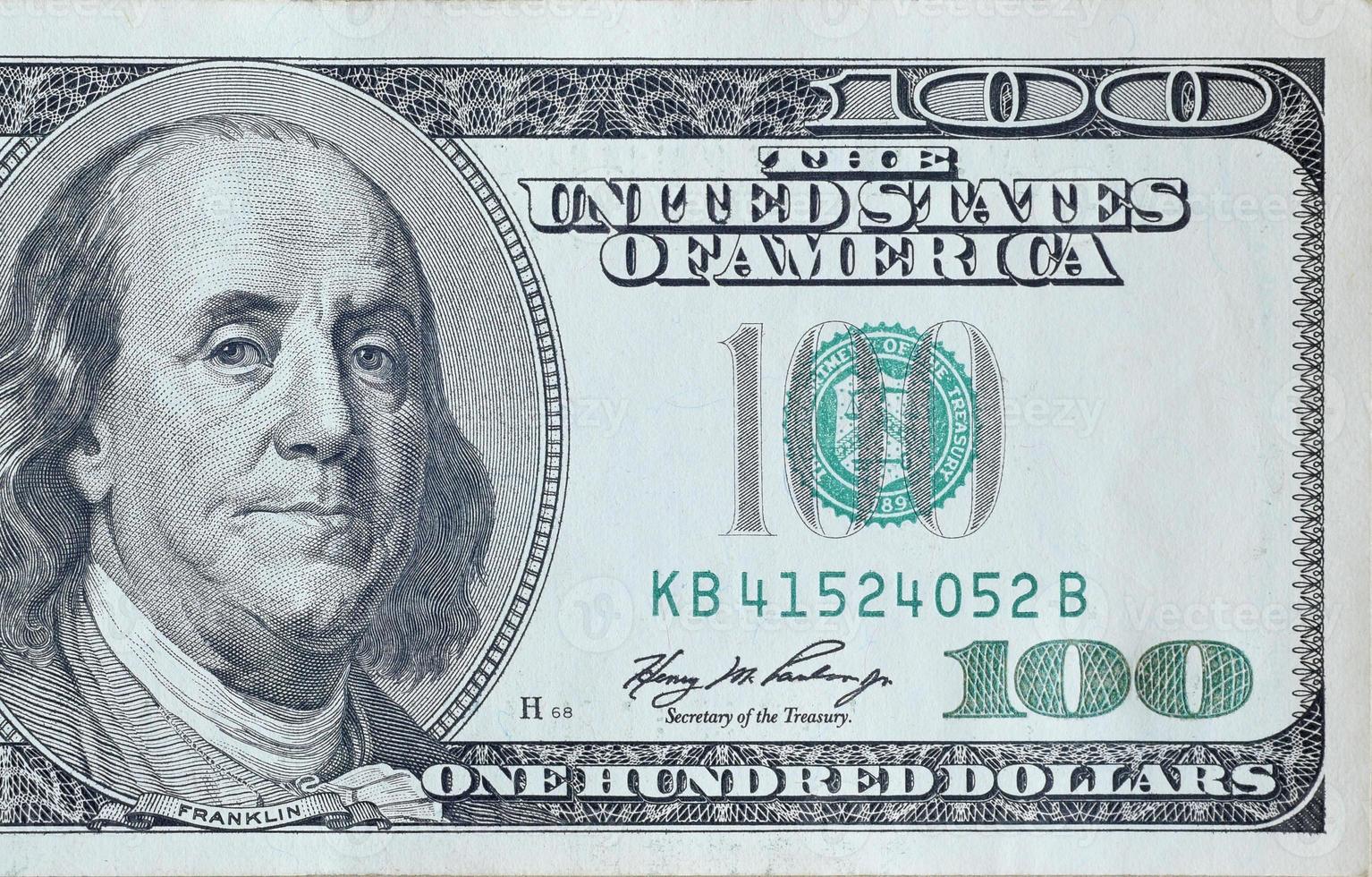 Portrait of US president Benjamin Franklin on 100 dollars banknote closeup macro fragment. United states hundred dollars money bill photo