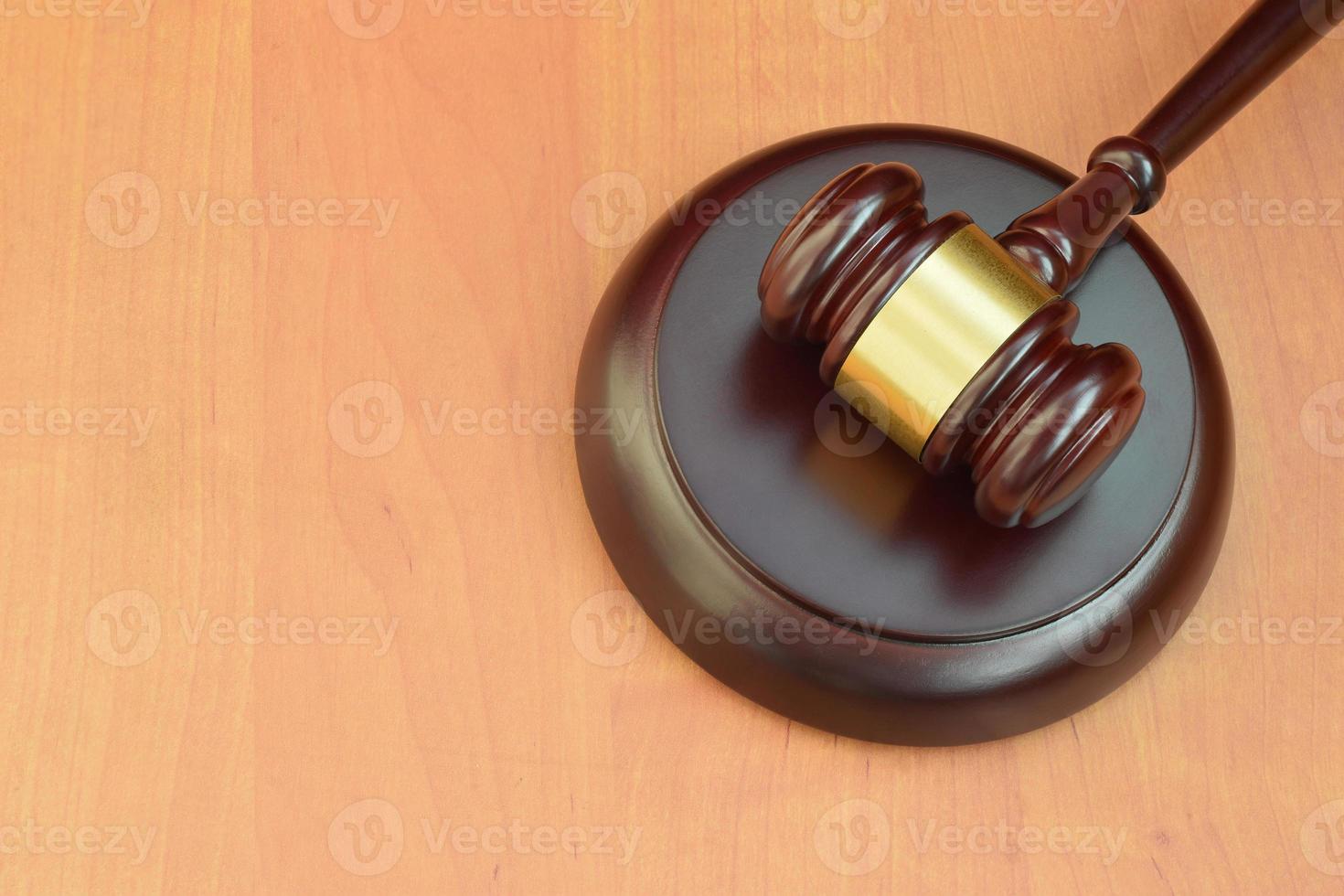 Justice mallet on wooden desk in a courtroom during a judicial trial. Law concept and empty space for text. Judge hammer photo