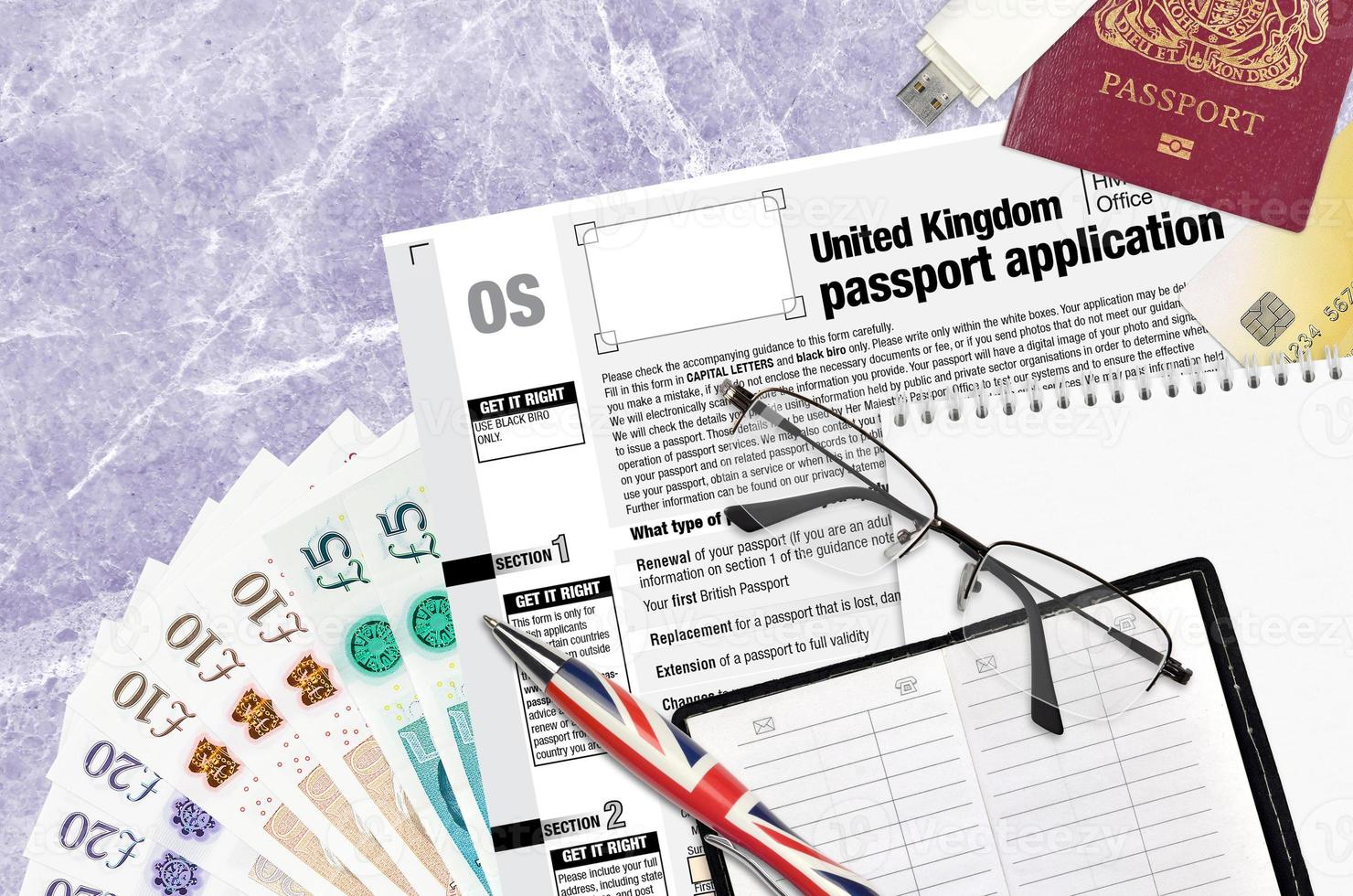 English form OS United Kingdom passport application from HM passport office lies on table with office items. UK passport paperwork photo